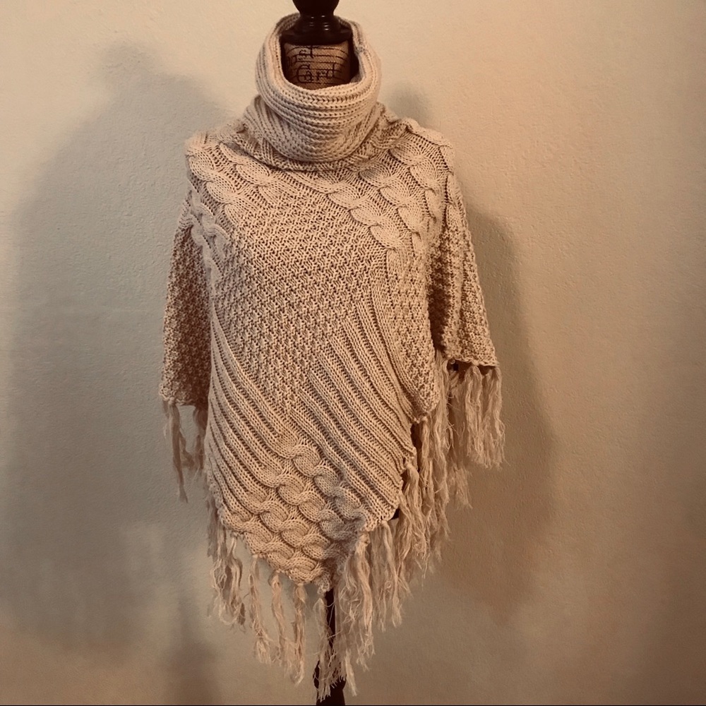 Beige knitted poncho with fringe